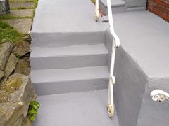 After pictures of a porch patio and set up steps we power washed, repaired, resurfaced, applied primer, and (2) coats of elastomeric Saf-T-Dek grey paint.