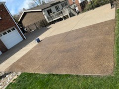 The patio and driveway were power washed, and you can see where the Browntone is being applied.  Browntone is an enhancer/sealer designed exclusively to treat exposed aggregate.