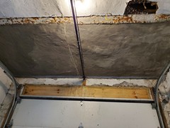 Our team was able to seal the concrete above the ceiling, so no further leakage will occur.  Then, we repaired the garage ceiling and gave it a new surface.