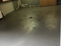 This garage floor needing power washing, crack repair, and resurfacing. The surface was finished with a skim coat of resurfacer
