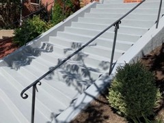 These steps required crack repair and a new finish. The finish is gray Saf-T-Deck elastomeric coating with non-skid surface.