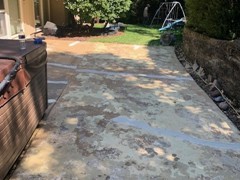 Though they do not show up well in the before photo, the second photo shows where cracks have been repaired on the back patio. Bronze colored Saf-T-Deck elastomeric coating was used to finish this restoration