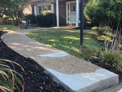 The end of this sidewalk needed to be rebuilt. We started by power washing to clear the surface. The we rebuilt the front and back corner with polymer cement before resurfacing the entire pad so that repairs are hidden and it has a fresh look.