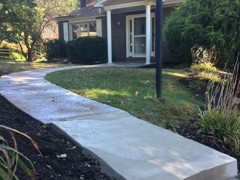 The end of this sidewalk needed to be rebuilt. We started by power washing to clear the surface. The we rebuilt the front and back corner with polymer cement before resurfacing the entire pad so that repairs are hidden and it has a fresh look.