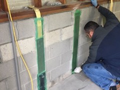 The owner of A Plus Concrete & Foundation Repair, Gary, works on each stabilization project and is a Master Installer.  Here he is applying the epoxy glue to a carbon strap.